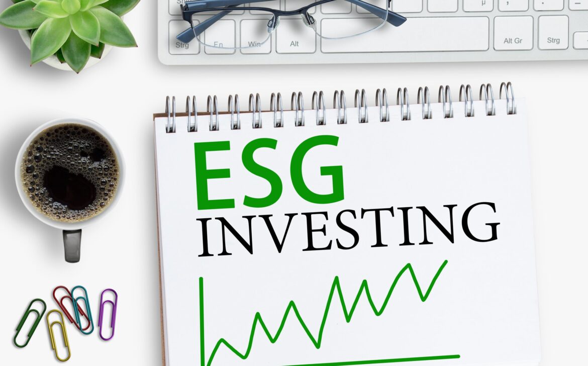 ESG investing results sign on notebook with keyboard and coffee,